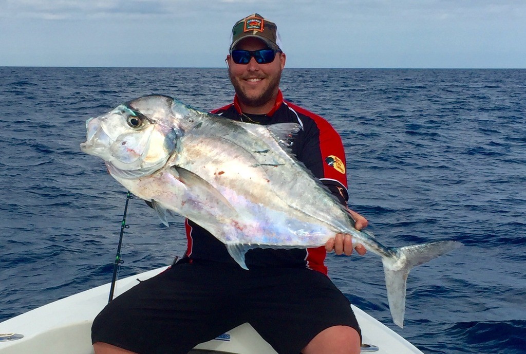 Dylan Hubbard showing off a monster african pompano from a recent Flying HUB private charter at Hubbard's Marina