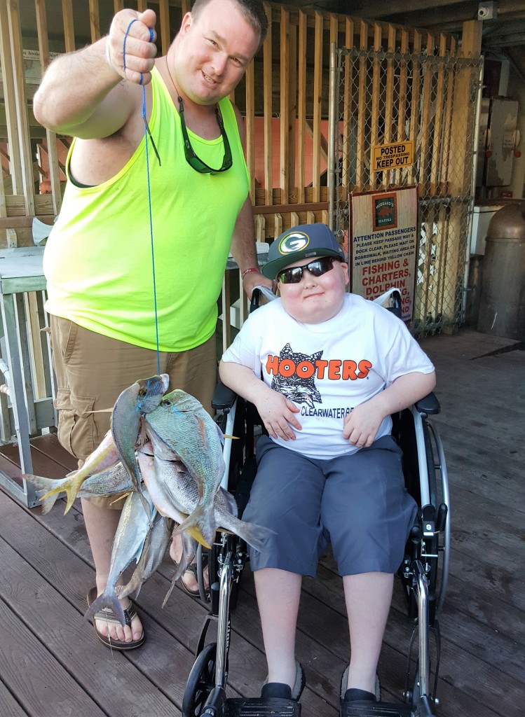 Left-Right- Jesse Johnson and his son Ryan Johnson from Wisconsin showing off Ryan's catch from his Make a Wish foundation trip with Hubbard's Marina