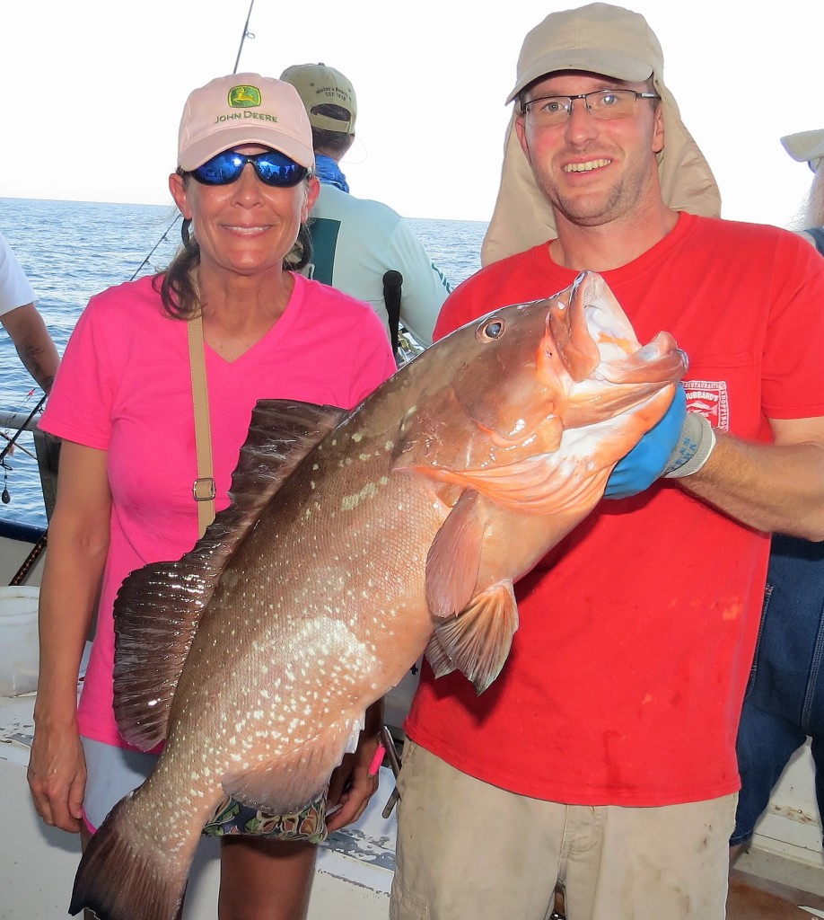 Left-Right - Michelle Godwin from Georgia showing off her 17lb Red grouper and first mate Will McClure from the 39 hour at Hubbard's Marina