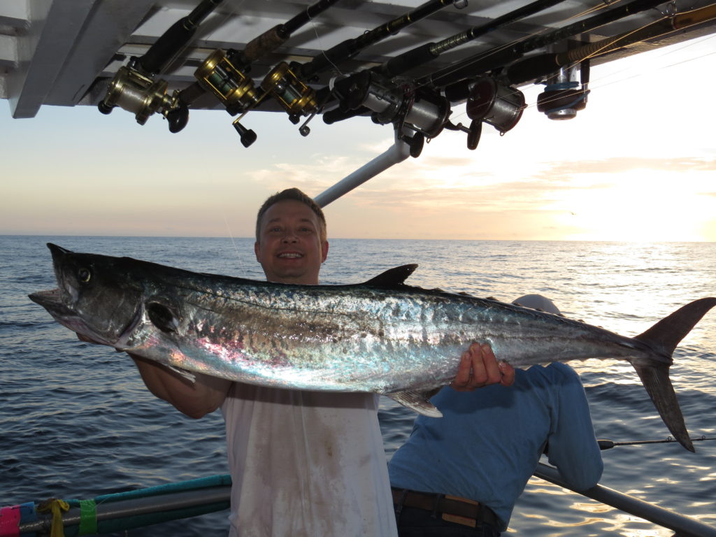 Dr. Tony Holowko from Michigan showing off a monster kingfish he caught while trolling on the Hubbard's Marina 44 hour full moon trip