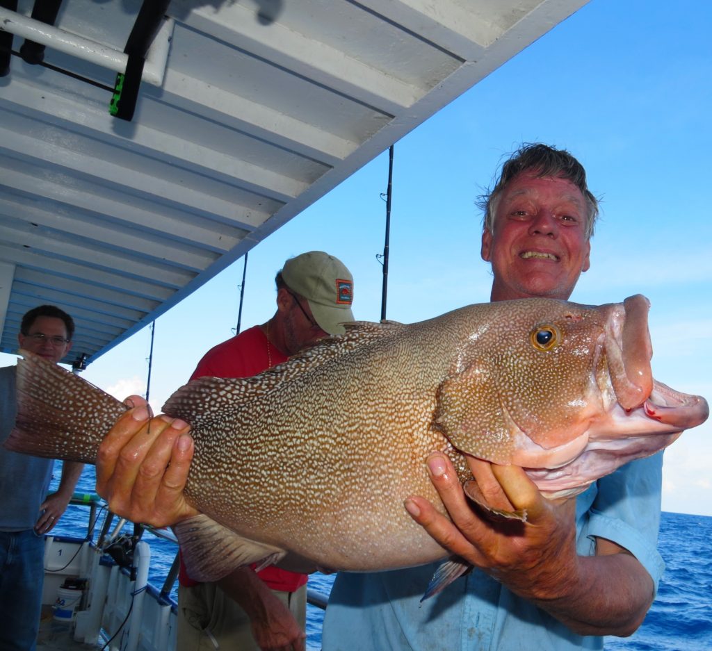 Keith Underwood showing off his monster kitty Mitchell grouper from the long range deep sea fishing trip at Hubbard's Marina