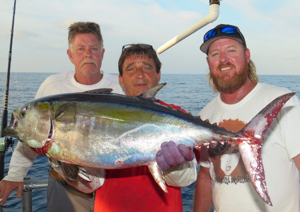 Left-Right David Underwood of Underwood construction, Ritchie Gollis, and Andrew Boyd showing off a monster blackfin tuna from the 63 hour at Hubbard's Mairna