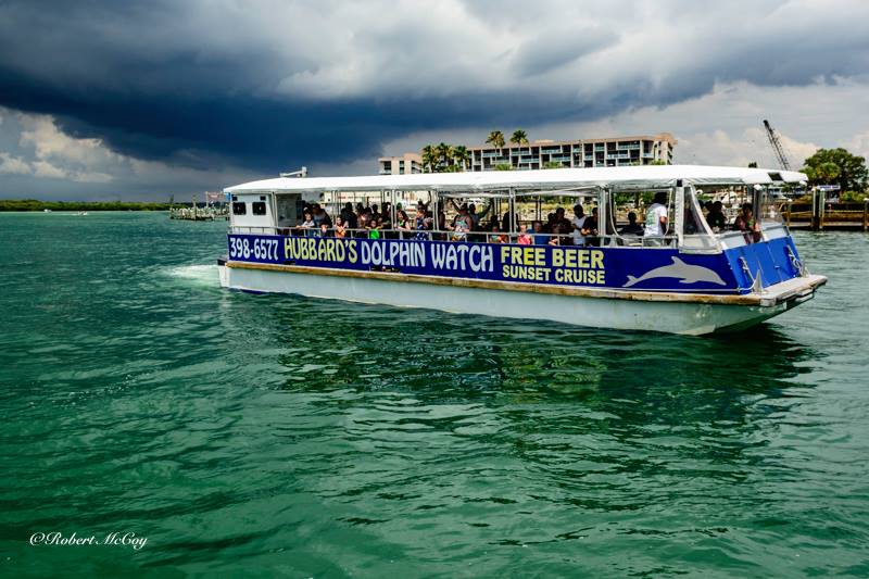 Captain Jacks Dolphin corner - The big blue boat taking off from a sumer time scattered shower PHOTO BY- Robert McCoy