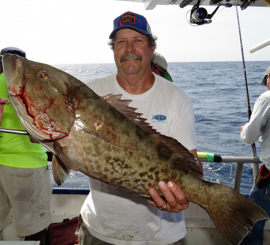 Dan Jackman from West Palm showing off a nice thick grouper he caught on the 39 hour at Hubbard's Marina