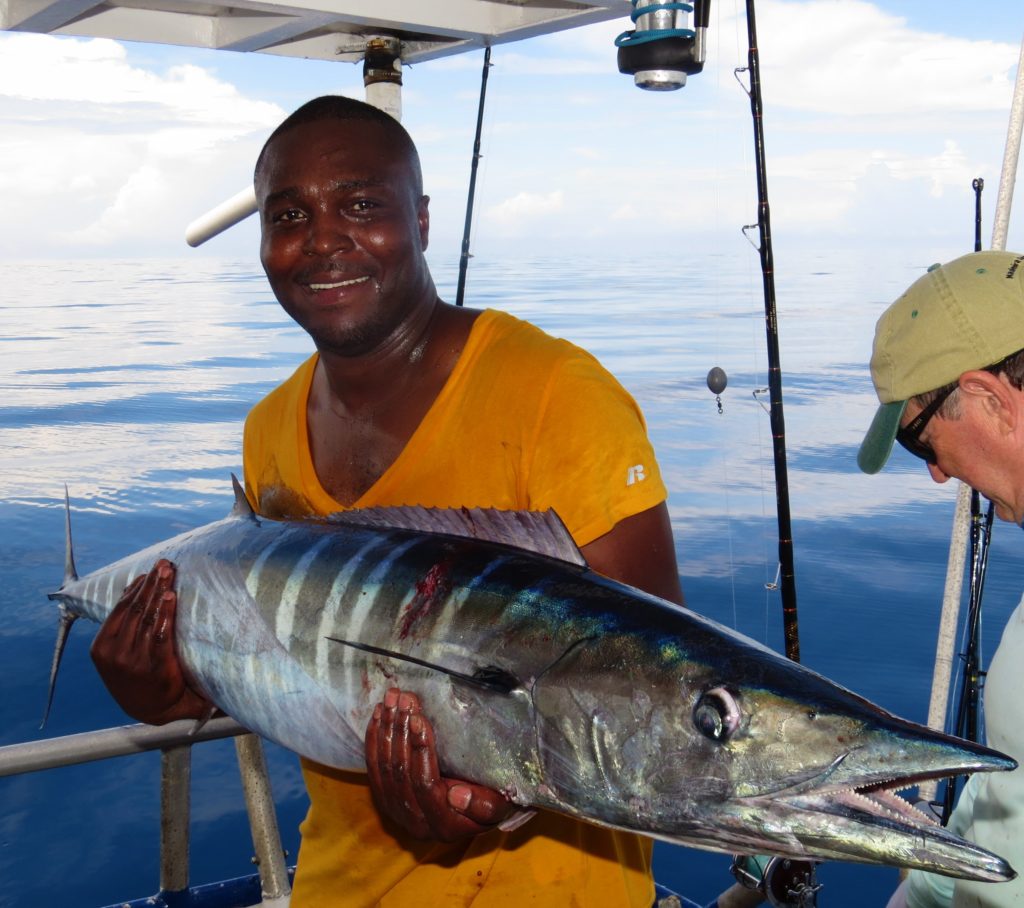 Jean Tour from Georgia showing off his 65lb wahoo he caught while flat lining on the 39 hour at Hubbard's Marina