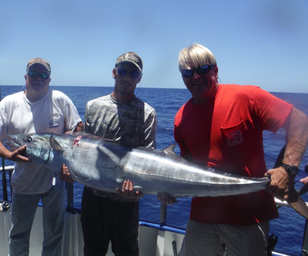 Left-Right- Capt. Bobby Peruche, Chad Andrews from Sarasota, and 1st Mate Jeff Ballard showing off Chad's 88lb wahoo he caught flat lining off the 12 hour trip at Hubbard's Marina
