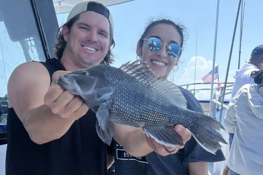 Captain Sebastian 'Seabass' holding a seabass caught on hubbards marina deep sea fishing trip