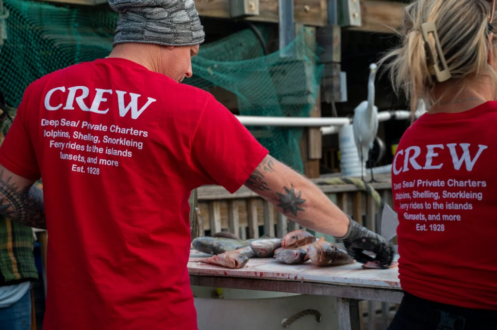 Hubbard's Marina Crew members fillet fish after private charter