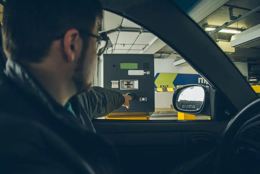 person grabbing parking reciept